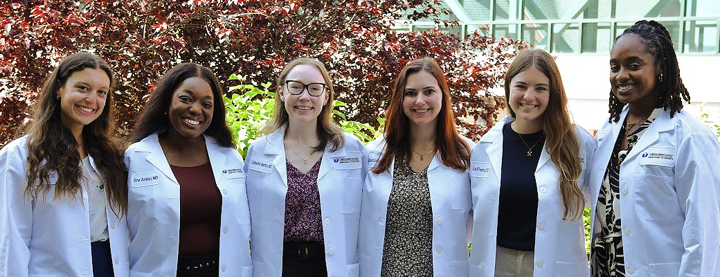 Six people wearing white coats