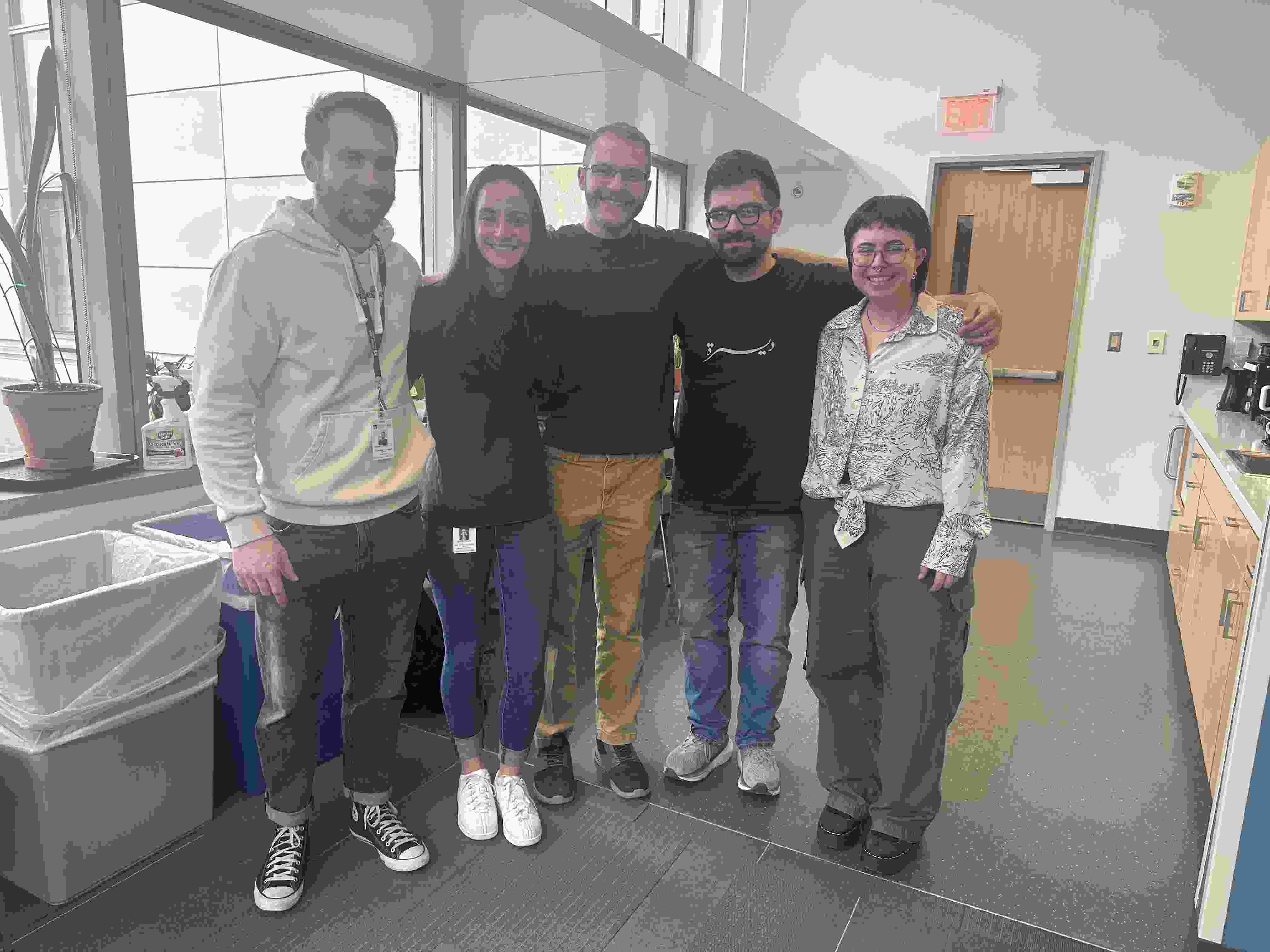Alterman lab members standing outside of the lab