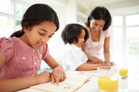 Mother helping children with homework