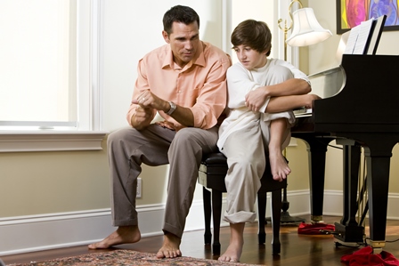 Serious father talking to teenage son