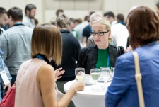 photo of people sitting around tables and conversing