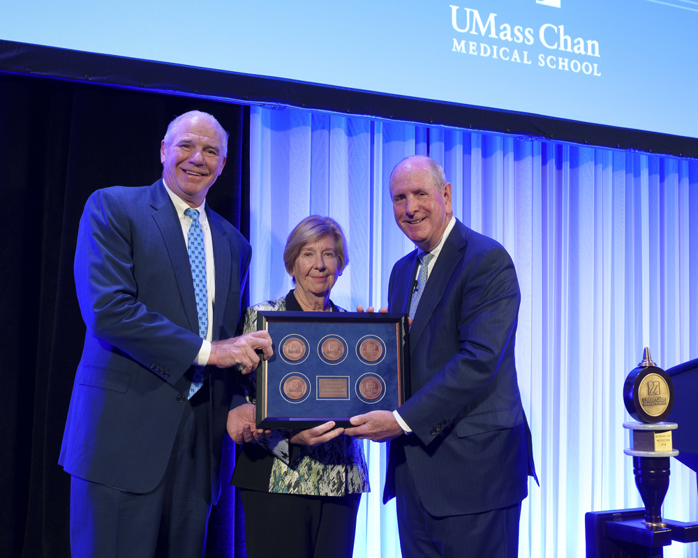 Chancellor Collins (right) presented a framed version of the UMass Memorial Health endowed chair medals to UMass Memorial Health CEO Eric Dickson, MD, and UMass Memorial Health Board of Trustees Chair Lynda Young, MD.