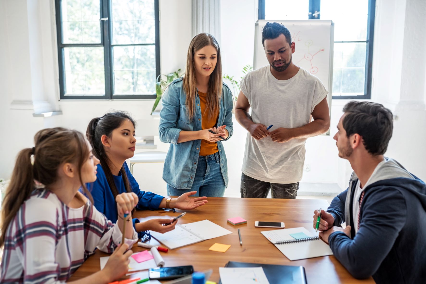 group of teens having a meeting round a table