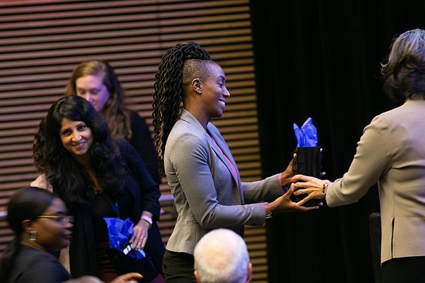 Ganga Bey, of the Person and Kiefe labs, receives her business cards and laser pointer—a GSBS tradition.