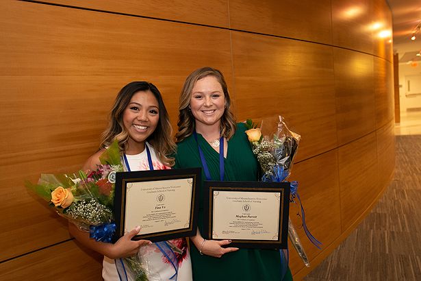 Students Tina Vo and Meghan Parrett celebrate after the pinning ceremony.