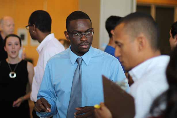 Nile McCullough (center), a junior at Southwestern Oklahoma State University, is pictured with (at right) postdoctoral fellow and poster judge Regino Mercado-Lubo, PhD.