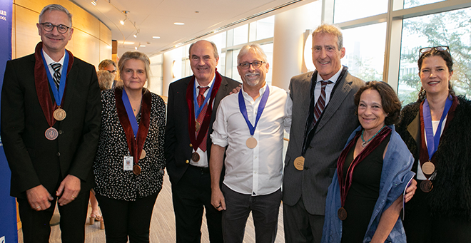 Endowed faculty members standing together wearing their medals