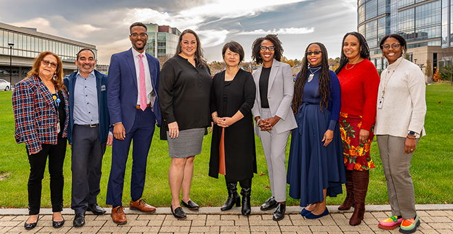 Fernanda Gama; Jorge Sanchez, MEd; Marcus Lambert, PhD; Jeanna Lee, PhD; Su Joun; Marlina Duncan, EdD; Candice Brown; Holly Brown; and Angela Printy stand together outside on the UMass Chan campus