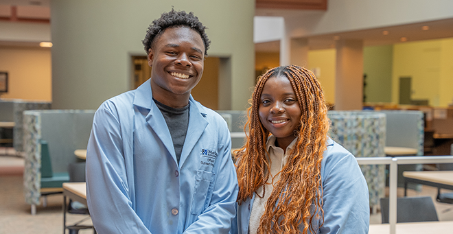 Photo of two students from the High School Health Careers Program 